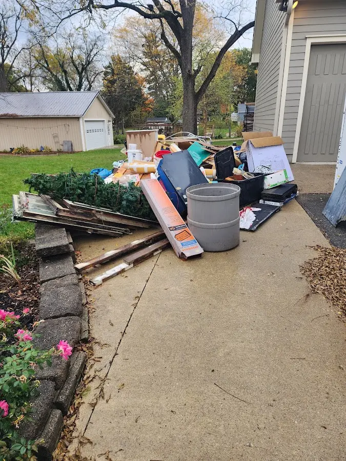 Dumpster being loaded with debris for Estate Cleanout Dumpster Rental in Wilsonville